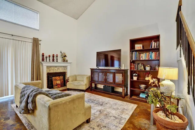 a living room with fireplace furniture and a book shelf