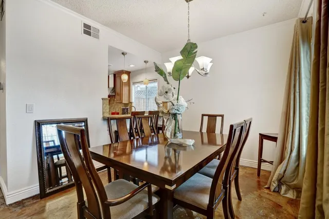 a dining room with furniture and chandelier