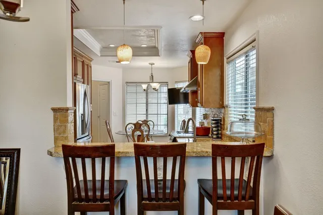 a view of a dining room with furniture and a window