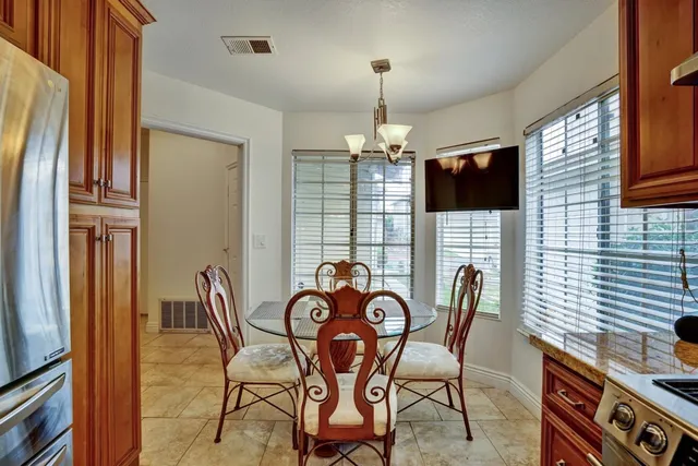 a view of a dining room with furniture wooden floor and chandelier