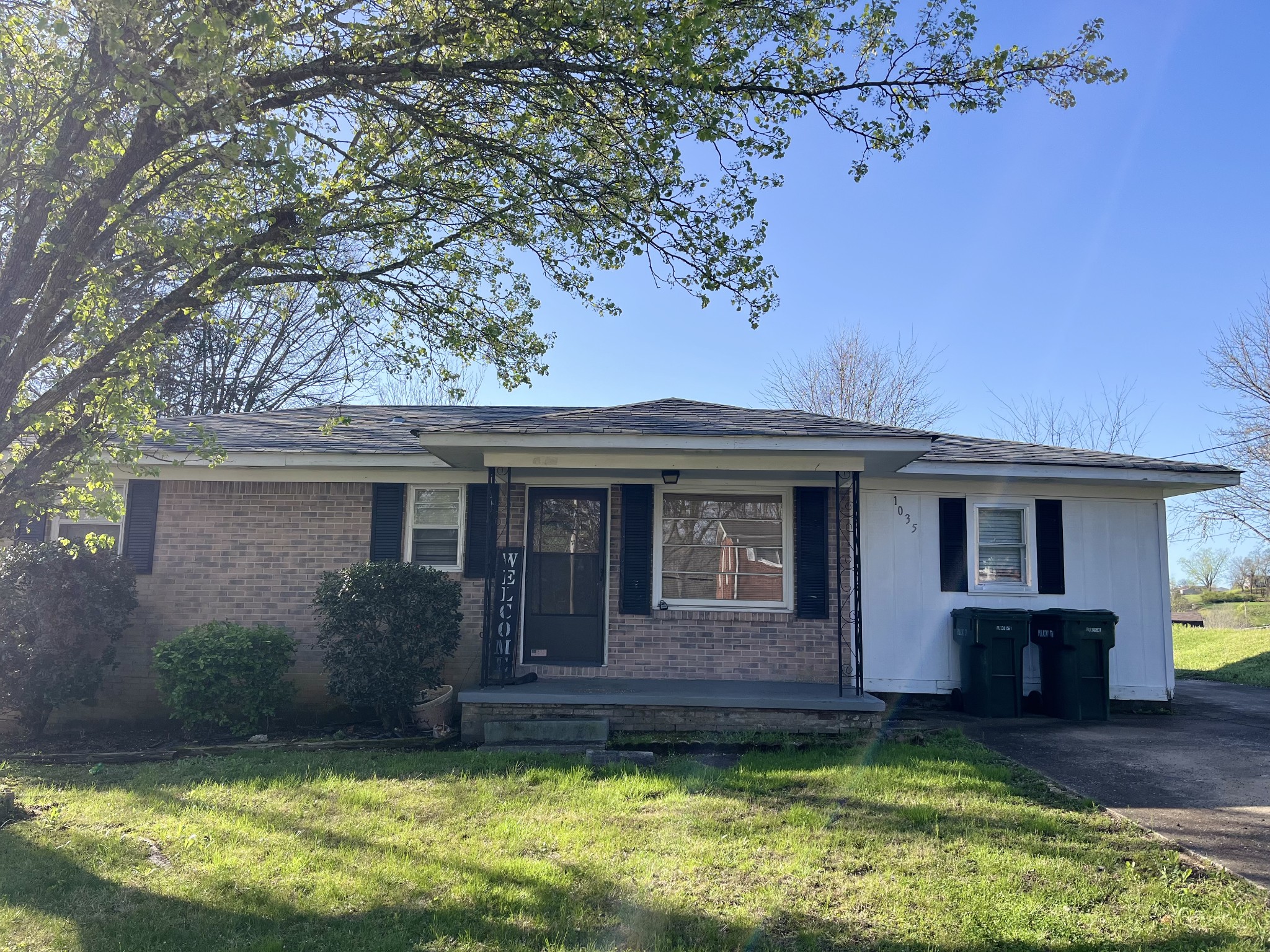 1035 North 3rd Street Pulaski, TN 38478 - Photo 2 of 14 a view of a house with a small yard plants and large tree