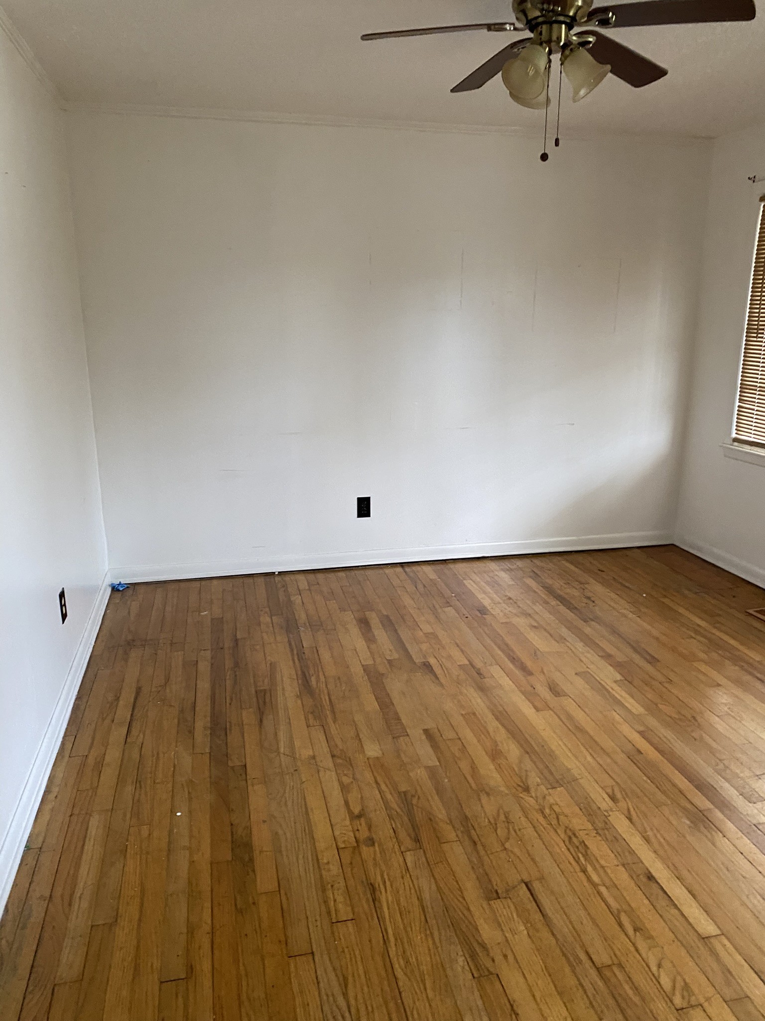 1035 North 3rd Street Pulaski, TN 38478 - Photo 5 of 14 a view of a room with wooden floor and a ceiling fan