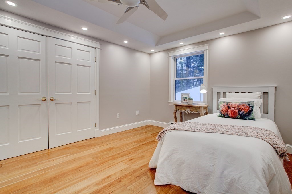 14 Pikes Hill Road Sterling, MA 01564 - Photo 23 of 40 a bedroom with a large bed and a chandelier