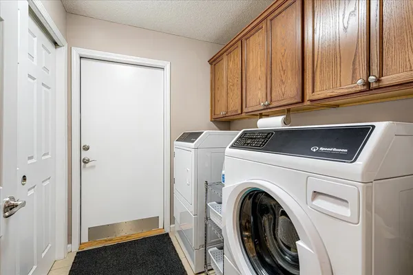 a bathroom with a granite countertop sink a toilet and shower