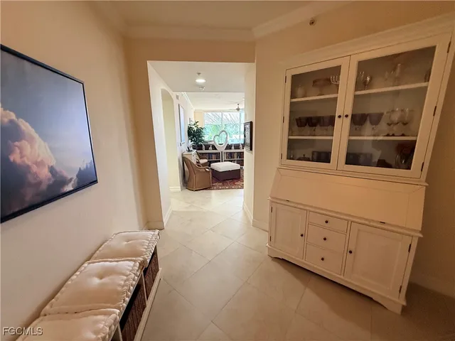 a spacious bedroom with a bed and a flat screen tv