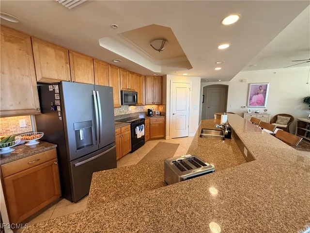 a kitchen with refrigerator and window