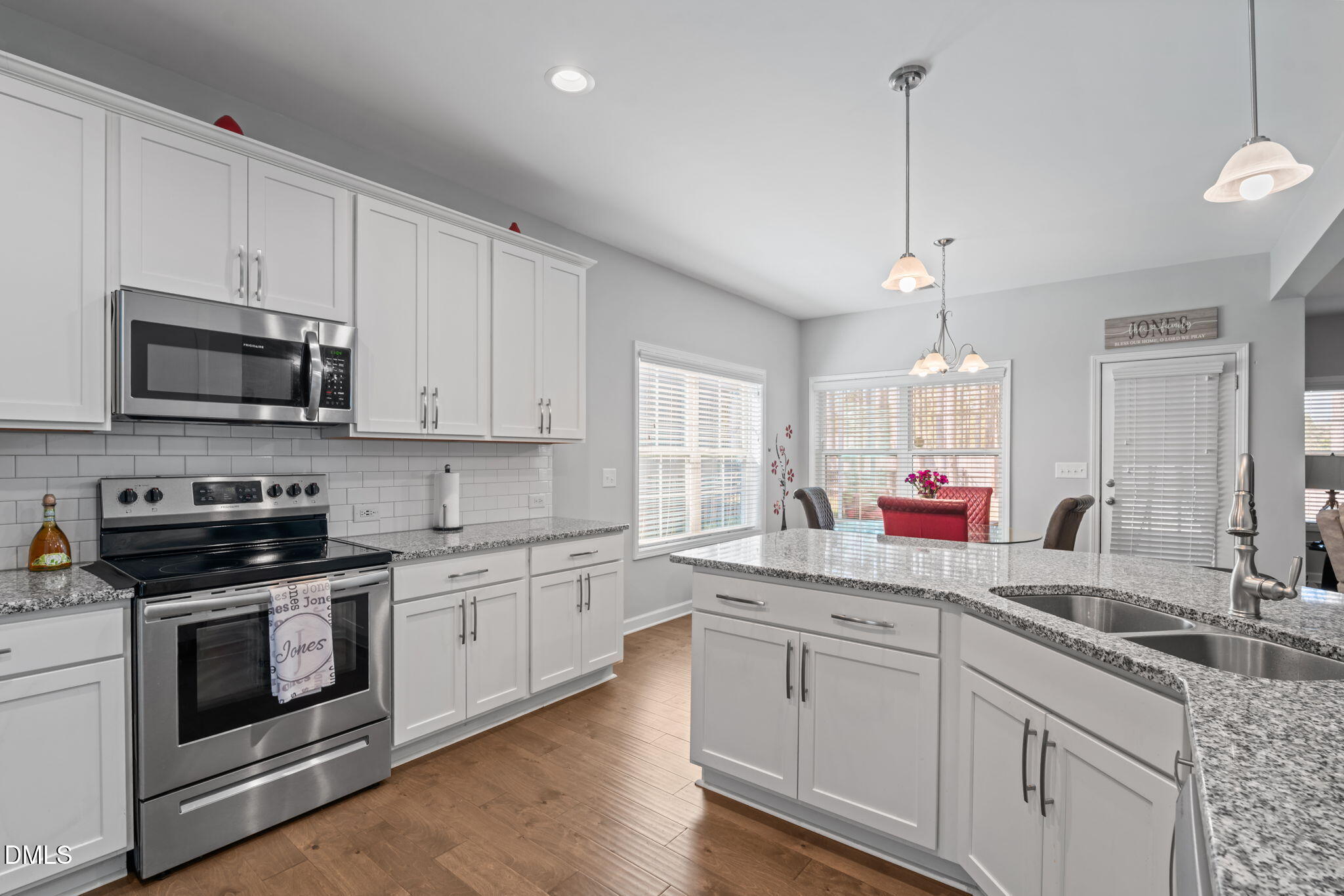 157 Timber Skip Drive Spring Lake, NC 28390 - Photo 15 of 44 a kitchen with appliances a sink cabinets and a wooden floor