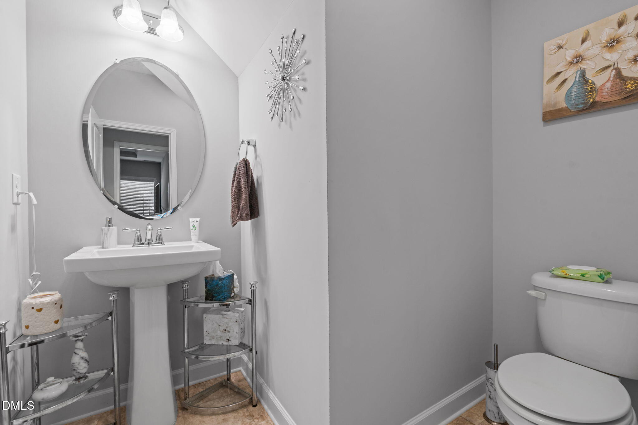 157 Timber Skip Drive Spring Lake, NC 28390 - Photo 18 of 44 a bathroom with a toilet a sink and mirror