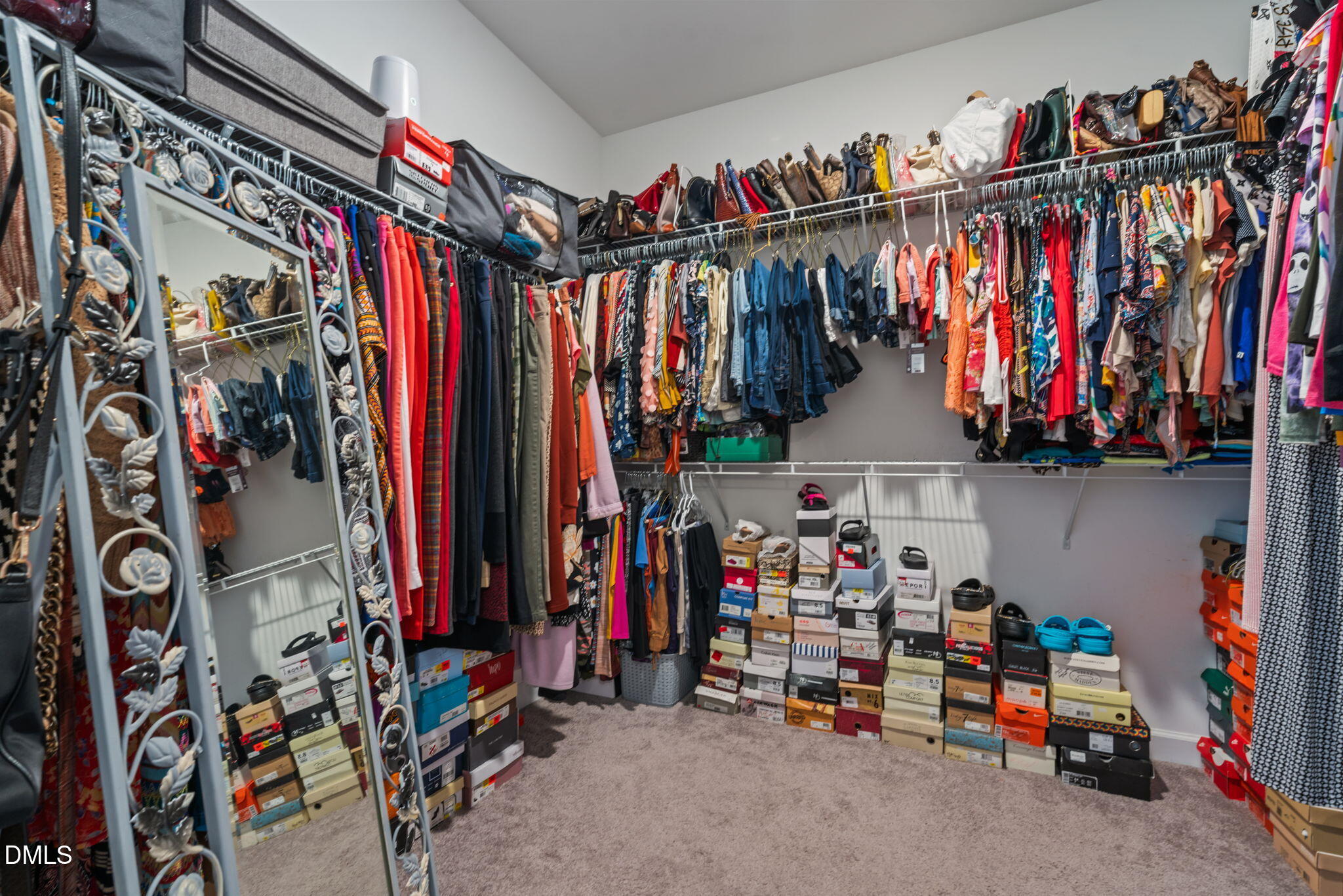 157 Timber Skip Drive Spring Lake, NC 28390 - Photo 24 of 44 a view of walk in closet with clothes and shoes