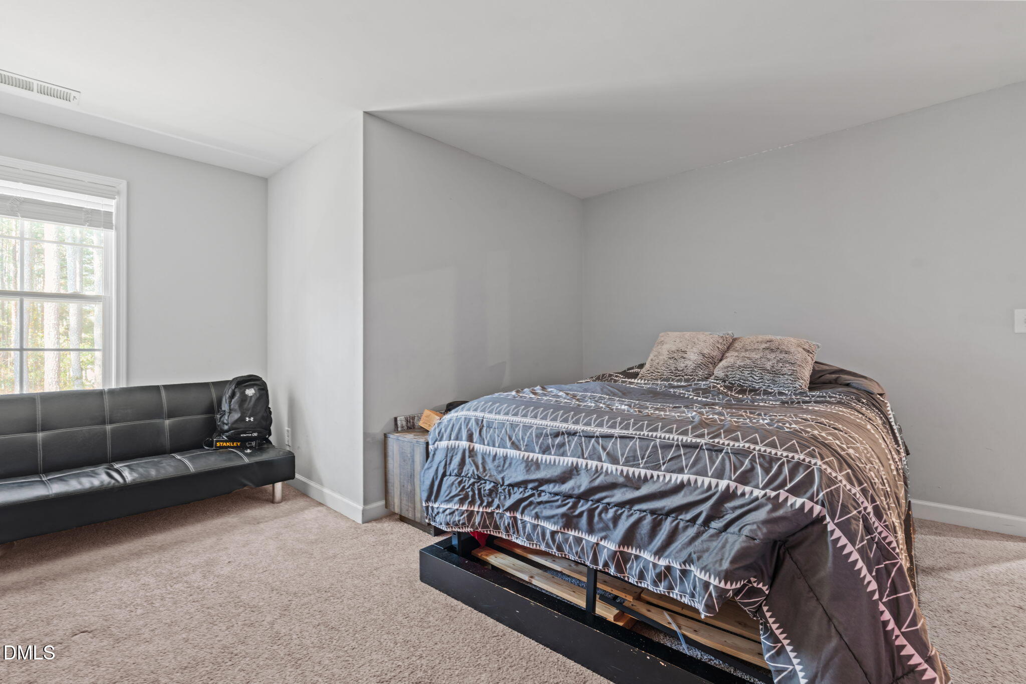 157 Timber Skip Drive Spring Lake, NC 28390 - Photo 30 of 44 a bed sitting in a bedroom next to a window