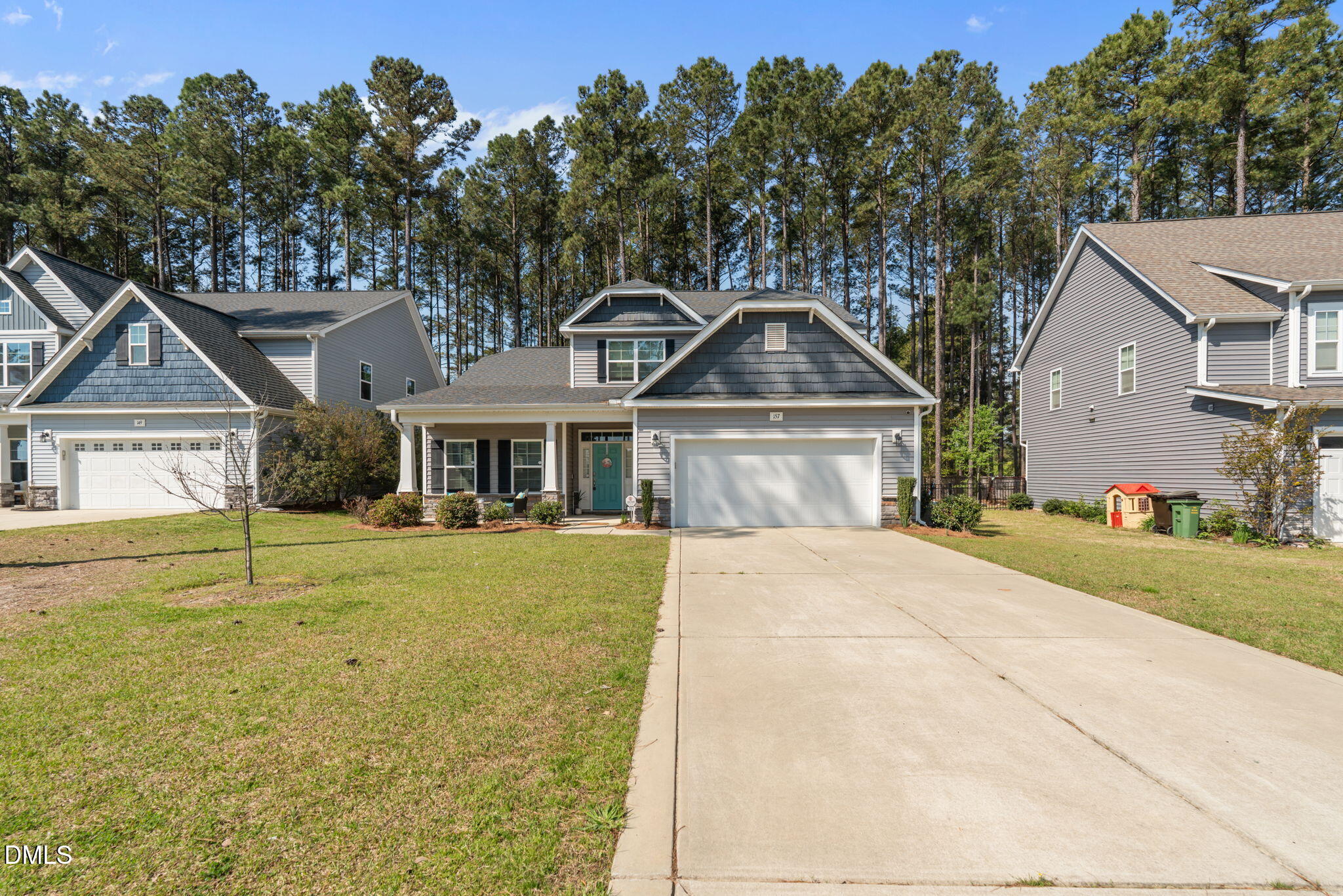 157 Timber Skip Drive Spring Lake, NC 28390 - Photo 34 of 44 a front view of a house with a yard and garage