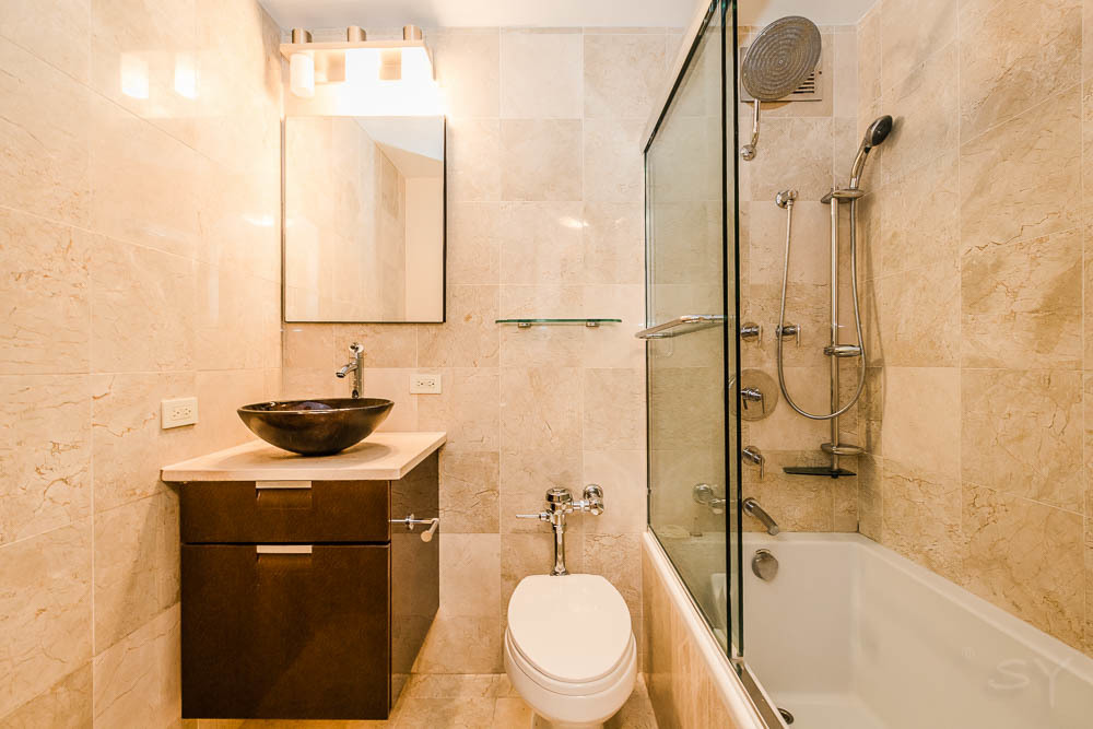 777 North Michigan Avenue, Unit 1307 Chicago, IL 60611 - Photo 13 of 17 a bathroom with a sink a toilet and shower