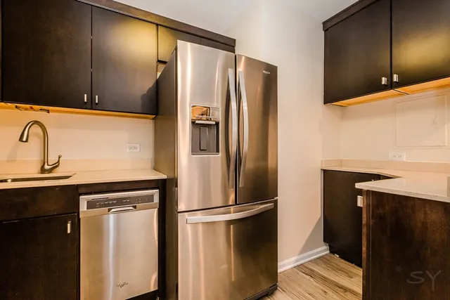 an entryway with wooden floor and cabinet