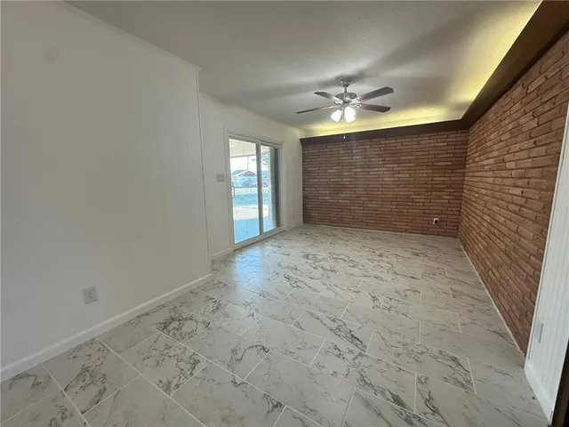 a view of an empty room with closet and a window