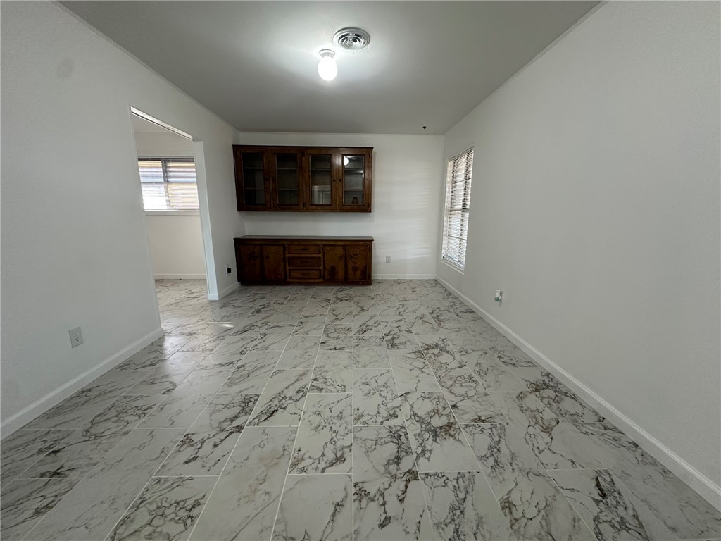 136 Daniel Moore Avenue Portland, TX 78374 - Photo 2 of 40 an empty room with windows