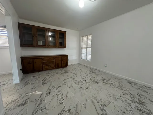 a living room with a large window and a flat screen tv