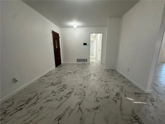 a kitchen with granite countertop a sink and cabinets