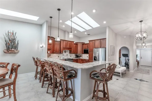 a kitchen with granite countertop a sink stove and cabinets