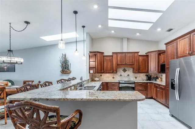 a kitchen with a sink stove and refrigerator