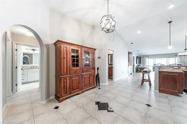 a spacious bedroom with a bed and a dresser next to a window