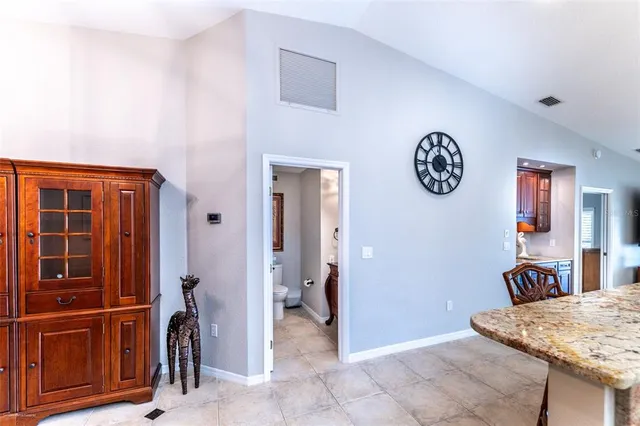 a bathroom with a granite countertop sink a toilet a mirror and shower