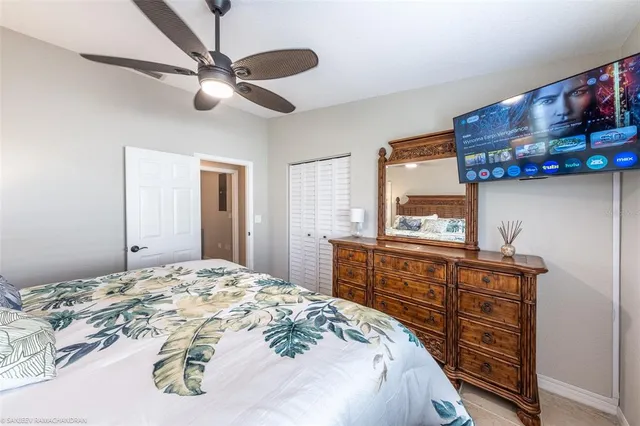 a bedroom with a bed and a chandelier