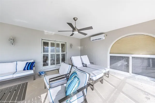 a bedroom with a bed a chandelier and dresser
