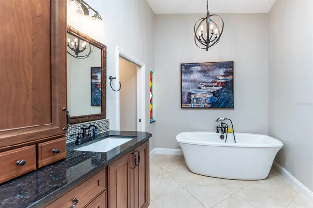 a living room with couches and kitchen view with wooden floor