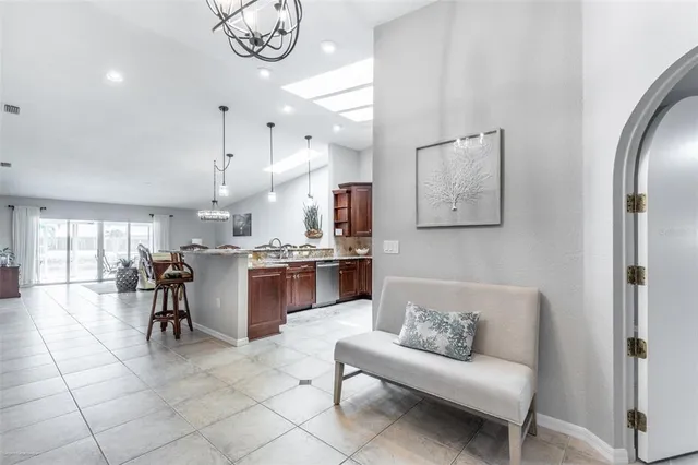 a living room with furniture and a kitchen