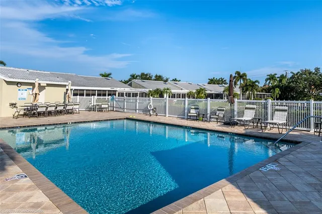 a view of swimming pool with outdoor seating and city view