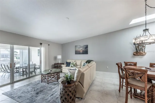a living room with furniture tv and a large window