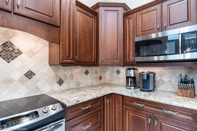 a kitchen with a table chairs a stove a dining table and chairs