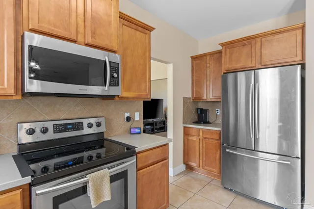 a kitchen with a refrigerator stove and microwave