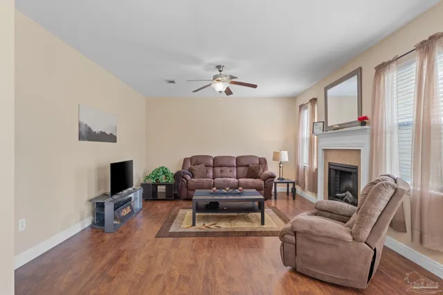 a living room with furniture fireplace and flat screen tv