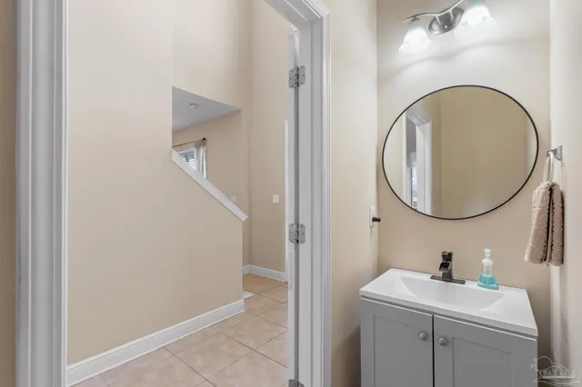 a bathroom with a sink a mirror a vanity and a toilet