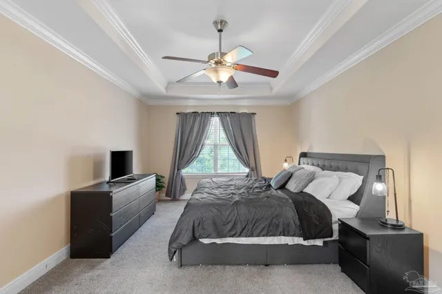 a living room with a bed furniture and a flat screen tv