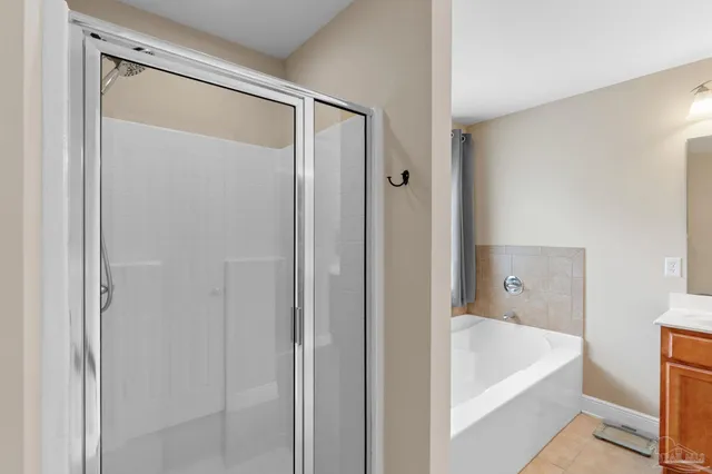 a bathroom with a tub and shower