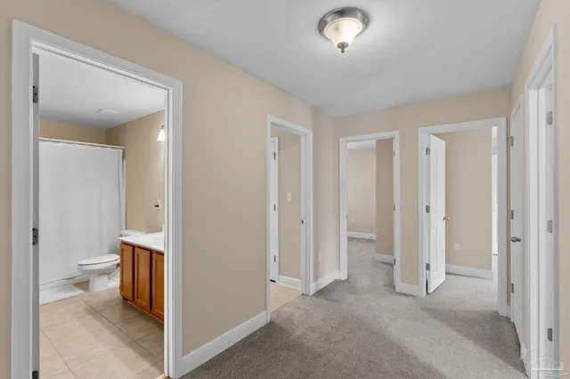a view of a hallway with toilet and a hallway