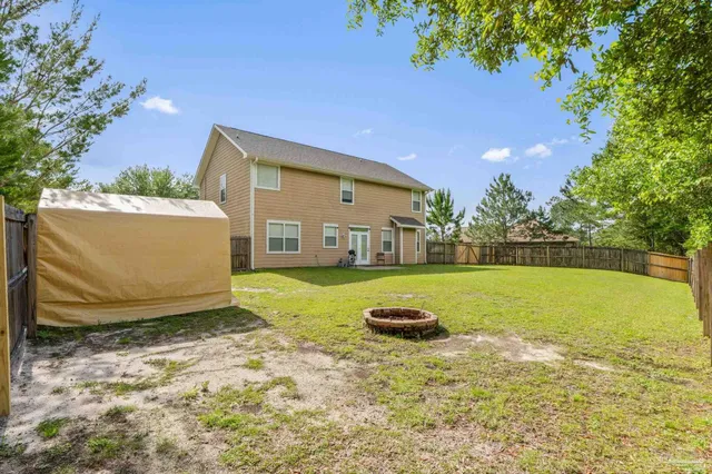 a view of a house with pool and a yard