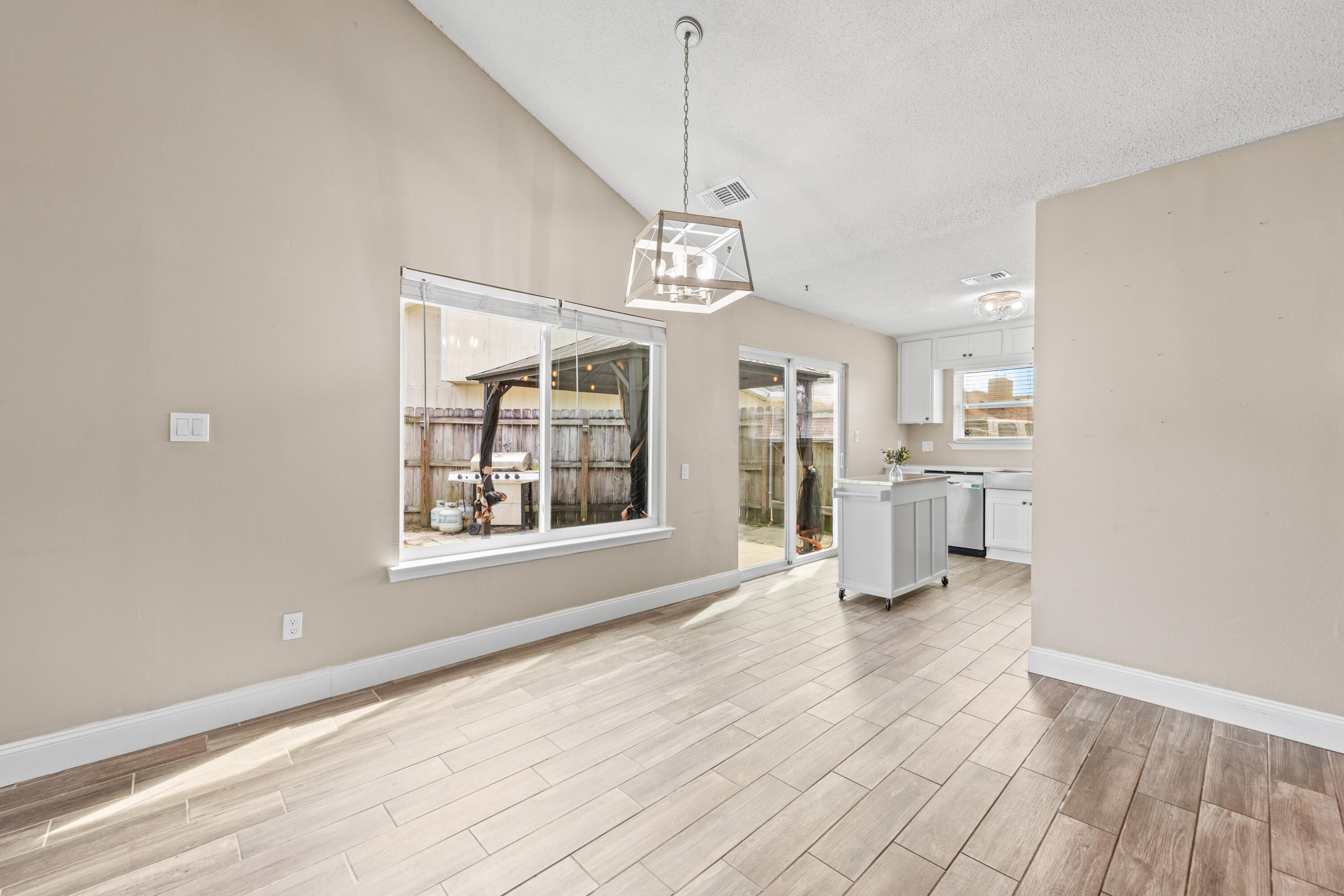 1833 Hunters Path Fort Walton Beach, FL 32547 - Photo 11 of 43 a view of an empty room with a window and kitchen view