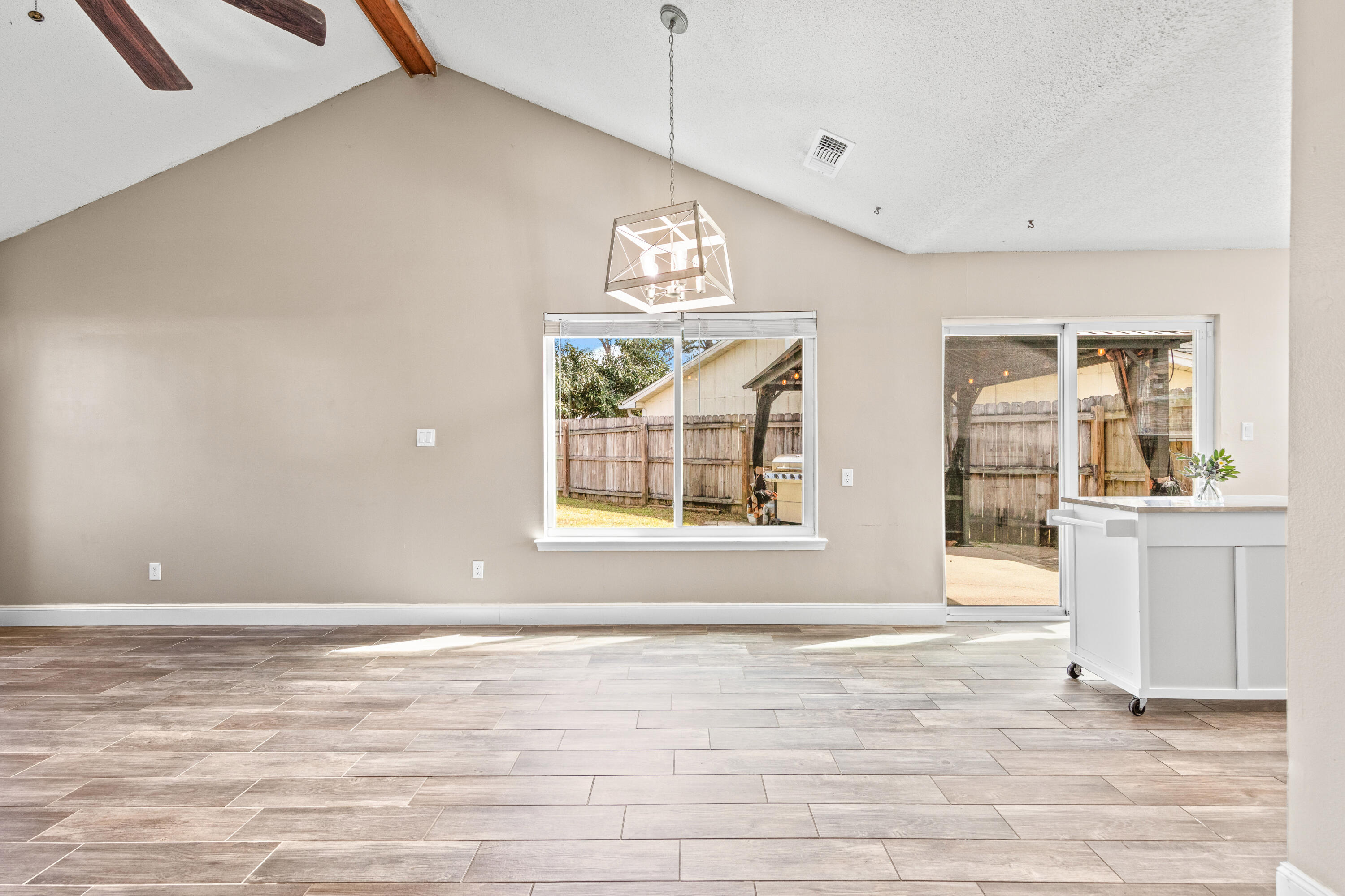 1833 Hunters Path Fort Walton Beach, FL 32547 - Photo 12 of 43 a view of an empty room with wooden floor and a window