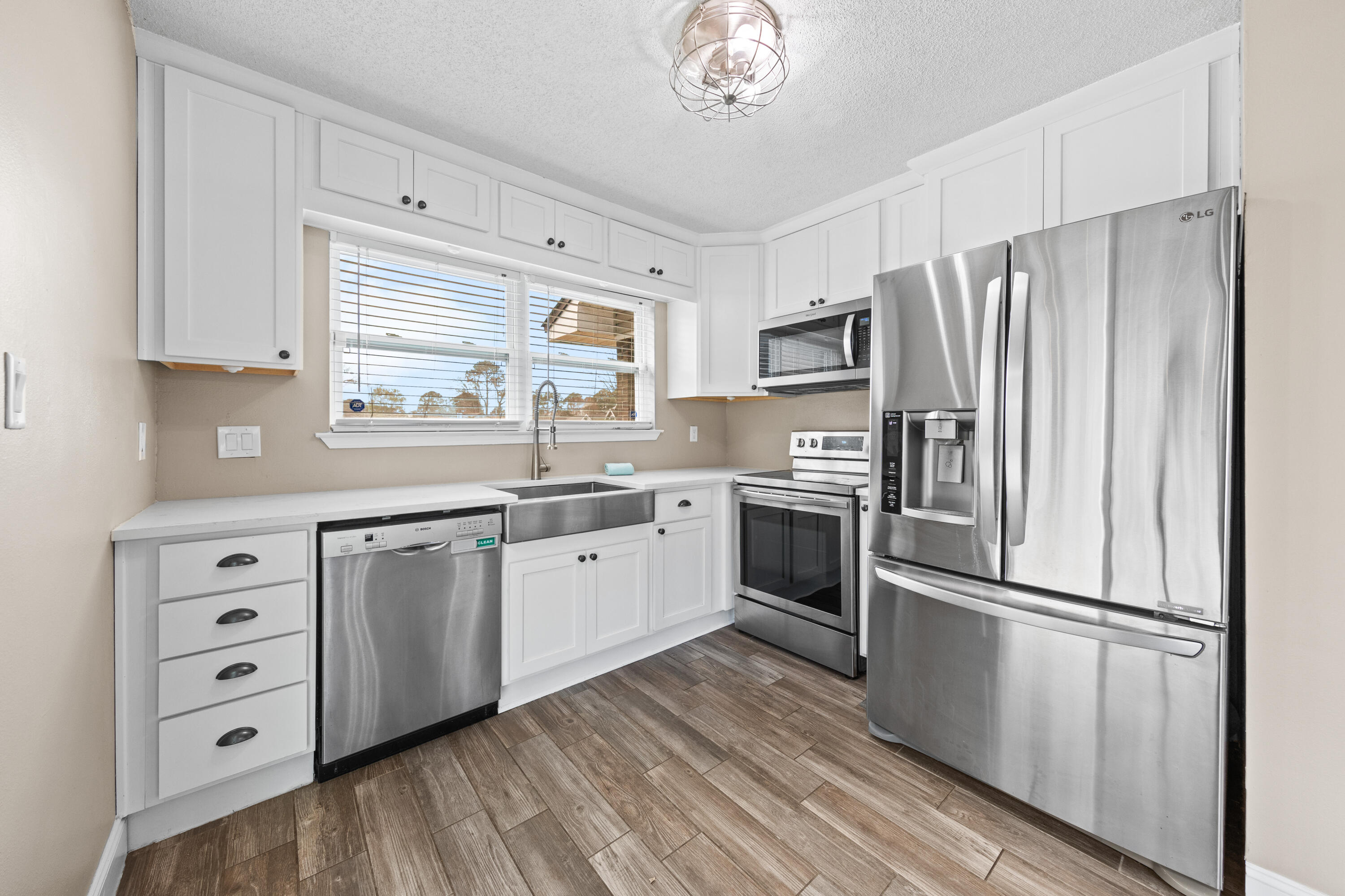 1833 Hunters Path Fort Walton Beach, FL 32547 - Photo 16 of 43 a kitchen with stainless steel appliances a refrigerator sink and cabinets