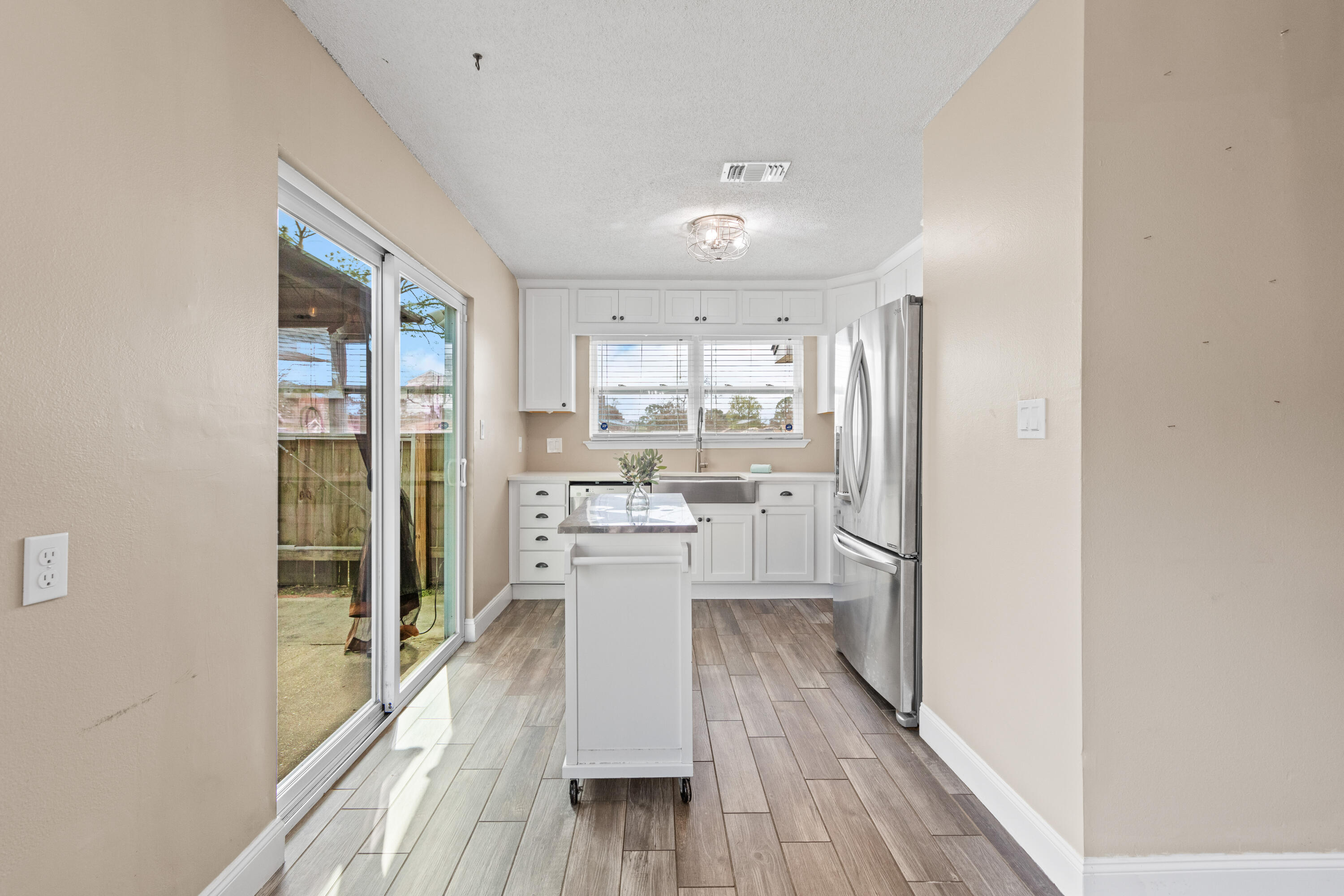 1833 Hunters Path Fort Walton Beach, FL 32547 - Photo 19 of 43 a kitchen with a refrigerator and wooden floor