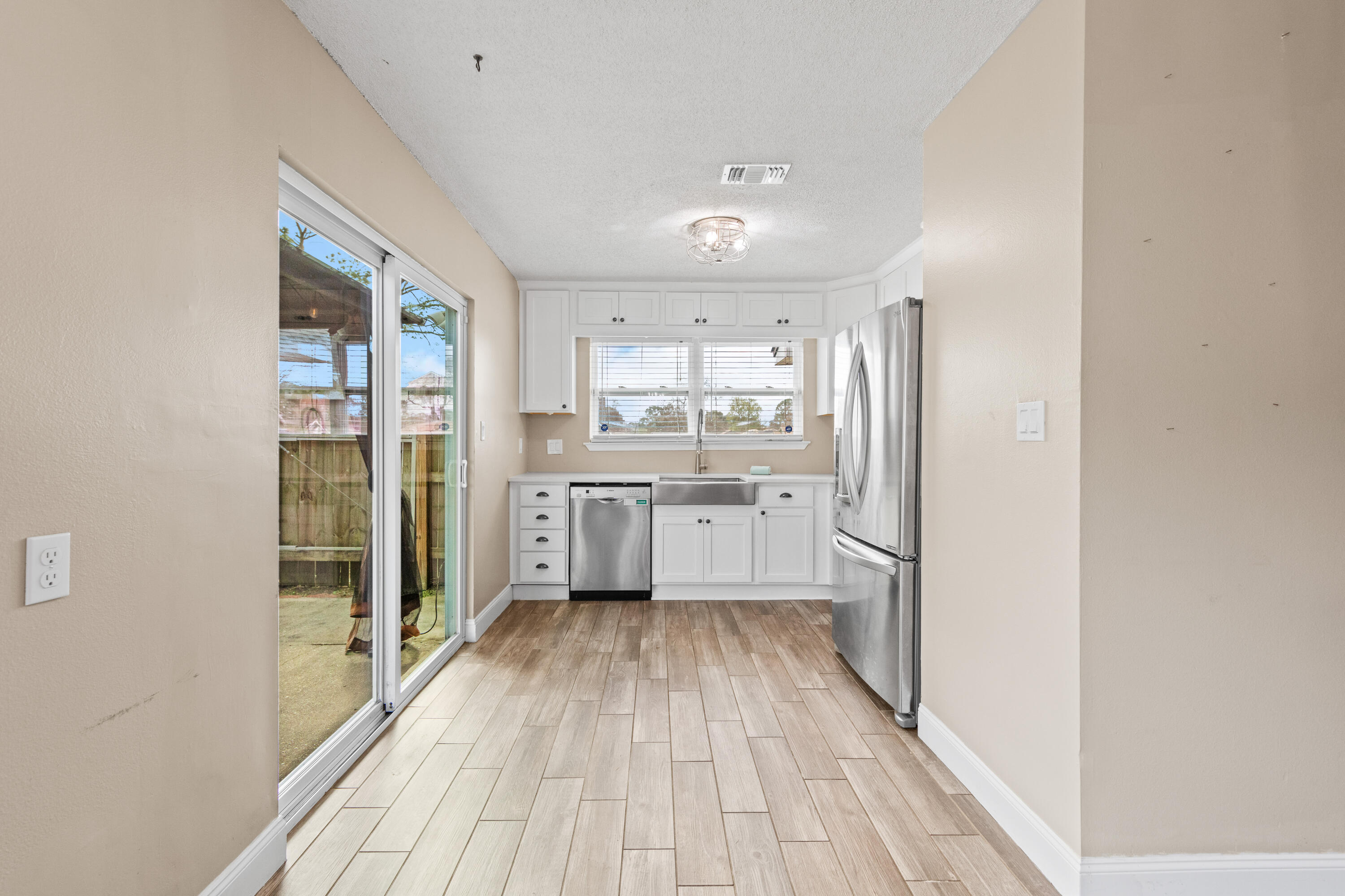 1833 Hunters Path Fort Walton Beach, FL 32547 - Photo 20 of 43 a kitchen with a refrigerator a sink and wooden floor