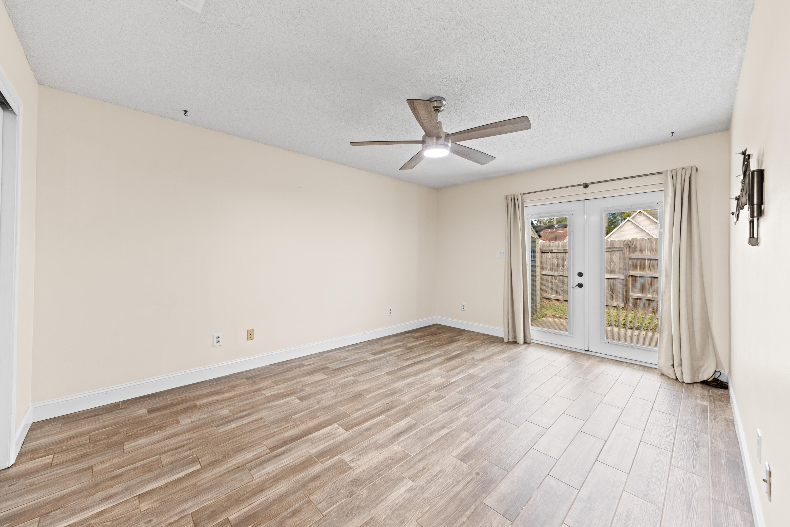 1833 Hunters Path Fort Walton Beach, FL 32547 - Photo 21 of 43 an empty room with wooden floor and windows
