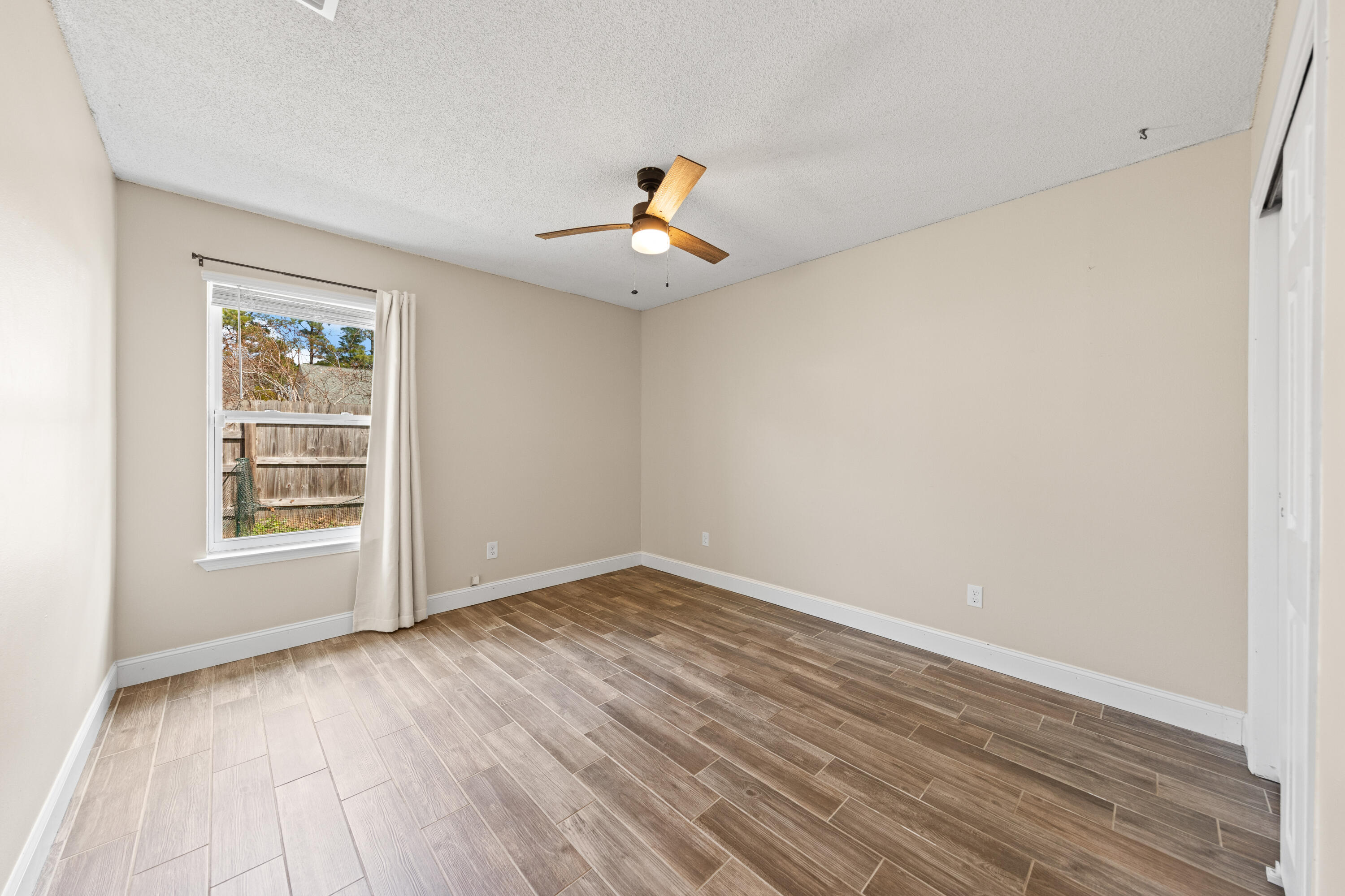 1833 Hunters Path Fort Walton Beach, FL 32547 - Photo 28 of 43 wooden floor in an empty room with a window