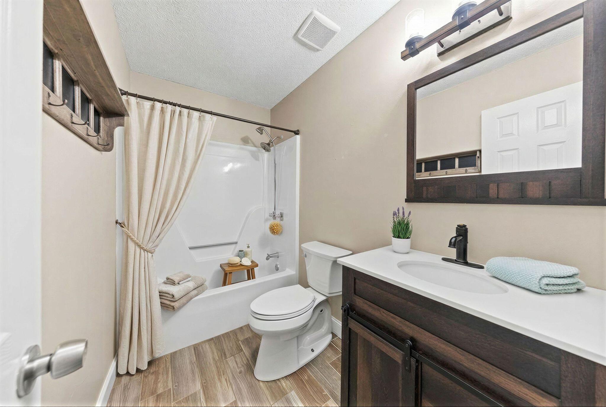 1833 Hunters Path Fort Walton Beach, FL 32547 - Photo 30 of 43 a bathroom with a granite countertop sink toilet a mirror and shower