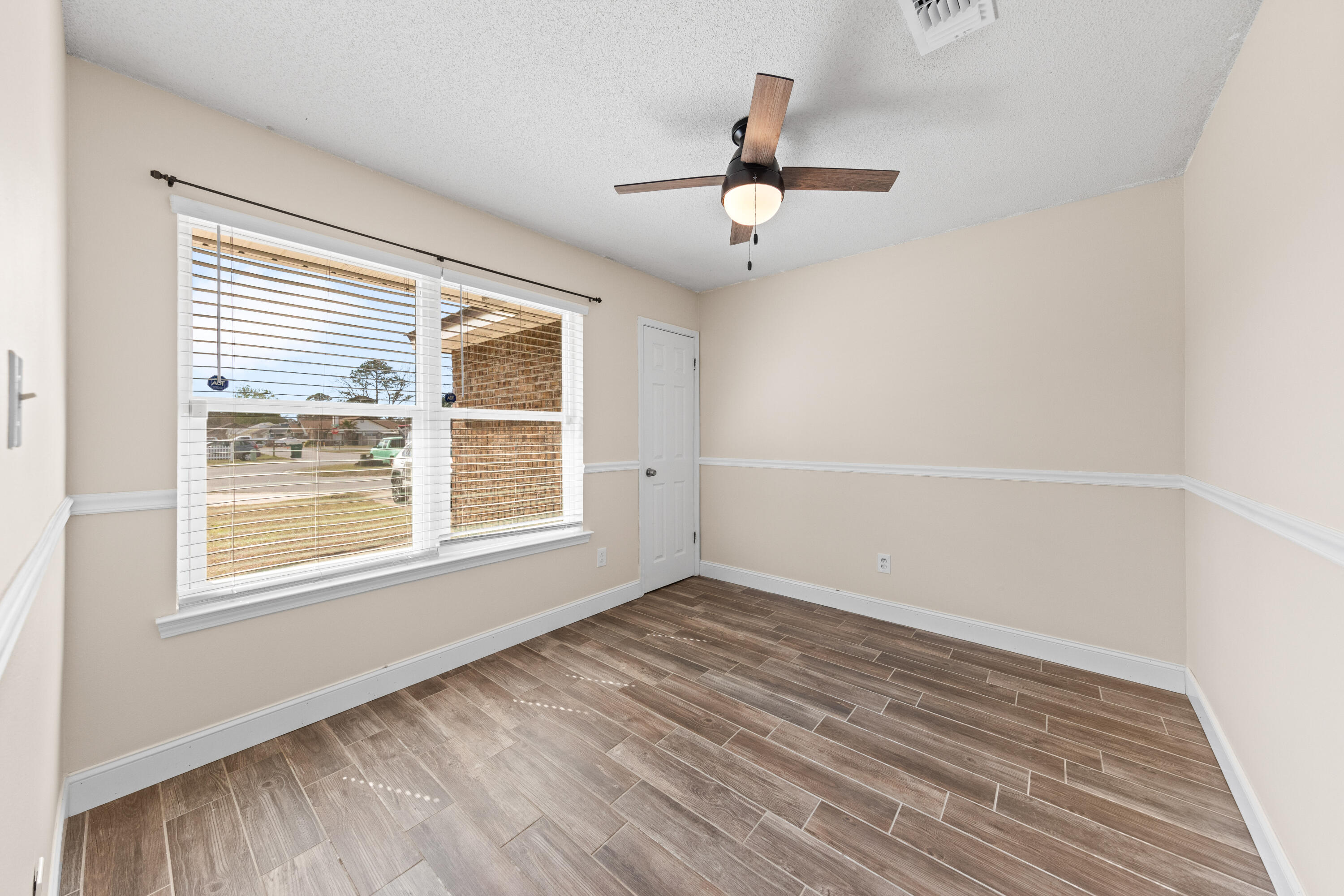 1833 Hunters Path Fort Walton Beach, FL 32547 - Photo 32 of 43 a view of an empty room with wooden floor and a window