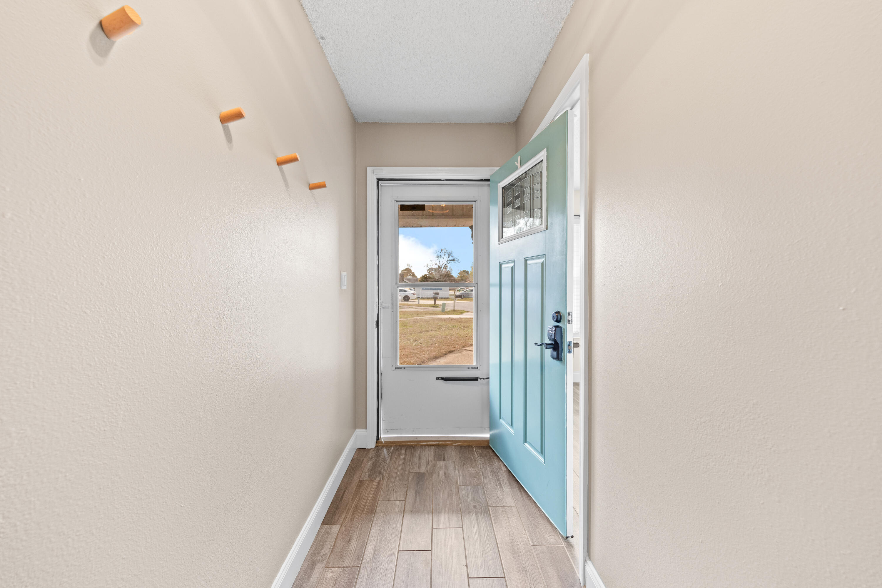 1833 Hunters Path Fort Walton Beach, FL 32547 - Photo 5 of 43 a view of a hallway with wooden floor