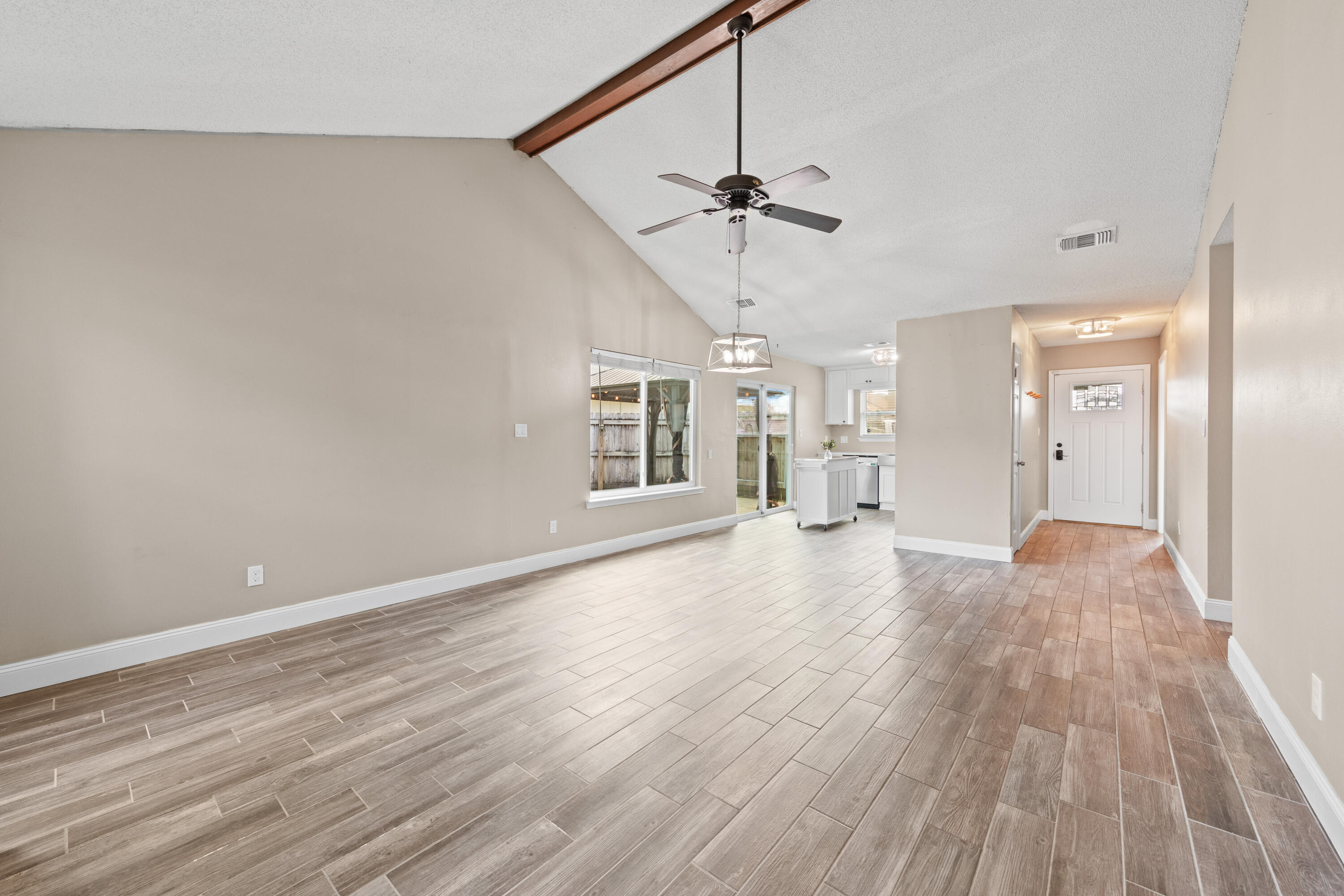 1833 Hunters Path Fort Walton Beach, FL 32547 - Photo 6 of 43 a view of empty room with wooden floor and ceiling fan